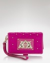 Leave it to Juicy Couture to take an iPhone essential and turn up the volume. Coolly crafted of nylon, this tech wristlet features interior pockets and space for a glamorous gadget.