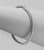 From the Silver Ice Crossover Collection. A twisted cable crisscrosses a diamond band in this graceful bangle of sterling silver and 14k white gold. Diamonds, 0.49 tcw Sterling silver and 14k white gold Diameter, about 2¼ Made in USA