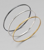 From the Skittle Collection. Three wispy hammered bangles - blackened and white sterling silver and 24k yellow gold - are minimalist in design with impactful results.24k yellow gold Sterling silver Imported