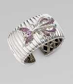 A substantial textural cuff adorned with a bird encrusted in amethyst, rhodolite and Swiss blue topaz. Sterling silver Amethyst Rhodolite Swiss blue topaz Kick mechanism closure Diameter, about 2½ Width, about 1½ Imported 