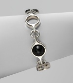 An unique and modern design featuring black agate spherical inset links and sterling silver circular links. Black agateSterling silverToggle closureLength, about 7½Imported 