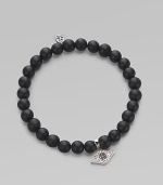 A protective symbol in many cultures, an evil eye charm of 14k white gold is richly set with diamonds and sapphires, and hangs from a stretchy strand of matte black onyx beads. Diamonds, 0.07 tcw Black onyx 14k white gold Diameter, about 2 (unstretched) Charm length, about ½ Imported