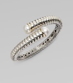 From the Bedeg Collection. A richly ribbed hinged cuff of gleaming sterling silver with accents of 18k gold has overlapping endcaps set with lustrous pearls.White pearlsSterling silver and 18k yellow goldDiameter, about 2¼Width, about ½HingedImported