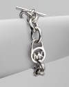 A sleek silvertone design with an iconic logo embellished lock on a chain link. Silvertone metalLength, about 8Toggle closureImported 