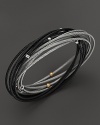 18K gold stations accent a mix of stainless steel cable bangles in black and grey PVD. From Charriol.