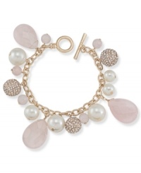 Rosy warmth, by Carolee. Rose quartz glass stones, glass pearls and sparkling charms embellish Carolee's cluster bracelet. With a secure toggle closure. Crafted in gold tone mixed metal. Approximate length: 8 inches.