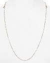 Small beaded stations dot a long, sterling silver chain from Links of London.