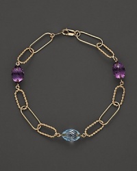 Faceted oval amethyst and blue topaz add rich sparkle to links of 14K yellow gold. By Nancy B.