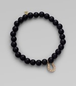 A good luck charm, depicted in diamonds set in 14k yellow gold, hangs from a simple strand of black onyx beads. Diamonds, 0.08 tcw Black onyx 14k yellow gold Diameter, about 2 Charm length, about ½ Stretch cord Imported