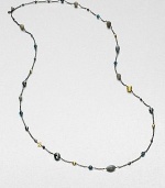 From the Bijoux Collection. Richly colored semi-precious stones in various colors and shapes mix with 18k gold beads on a delicate blackened sterling silver link chain. Hematite, labordarite, grey moonstone and blue topaz18k goldBlackened sterling silverLength, about 40Toggle closureImported 