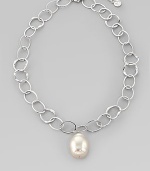 A large, lustrous white pearl drop dangles with creamy iridescence from a silvery chain of hammered open links. 22mm white baroque organic man-made pearl Rhodium-plated sterling silver Length, about 16, with 2 extender Lobster clasp Made in Spain