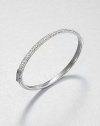 From the Brilliance Collection. Half of this graceful bangle is paved with sparkling rhinestones, the other half has a smooth, polished finish, with a handy hinge in between.GlassSilvertoneDiameter, about 2.5Hinged with push-lock claspImported