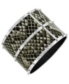 Predator perfect. Jessica Simpson's fierce bangle bracelet features a pvc python print set in a studded rhodium-plated mixed metal. Approximate diameter: 3 inches.