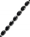 Stand out. Oval-cut onyx gemstones (18-3/4 ct. t.w.) and sparkling diamond accents adorn this chic bracelet. Crafted in sterling silver. Approximate length: 7-1/2 inches.