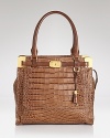 Richly embossed leather and signature details add special sophistication to this carry it all satchel. From Michael Kors.