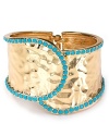 Nail this season's eclectic jewelry trend with this gleaming cuff from Cara. Crafted from metal plate with turquoise colored stones, this bohemian piece will work just as well for day as for night.