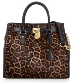 MICHAEL Michael Kors gives a classic tote design an edgy upgrade with leopard print haircalf, stud accents and signature hardware. But don't let this silhouette's luxe look fool you: it's roomy, pocket-trimmed interior perfects practical style.