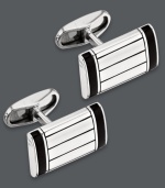 A dapper accent for any occasion: from office attire to black tie affairs. These sleek cuff links feature a rectangular shape, sterling silver setting and black onyx accents. Approximate length: 9/10 inch. Approximate width: 1/2 inch.