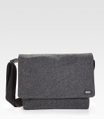 Sturdy and sleek in durable, water resistant waxed wool, detailed with leather trim and custom die-cast black hardware.Adjustable shoulder strapFlap closureLaptop interior pocket with tab closureOrganizing pocketsInterior zipper pocketsCotton liningWaxed wool exterior14 X 14 X 3Imported