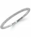 Bring on the sparkle! Juicy Couture's bangle bracelet flaunts shimmering pave crystals and an engraved logo at the inner ring. Crafted in silver tone mixed metal. Approximate diameter: 2-1/4 inches.