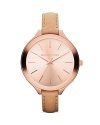 A curvy dial finished in rose gold plated metal steel tops a slim, sophisticated Michael Kors watch set on pristine leather strap.