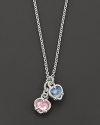 A twin heart necklace in pink crystal and blue quartz framed in sterling silver. Designed by Judith Ripka.