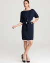 A modern take on the classic sheath, this navy MARC BY MARC JACOBS dress features tan trim, dolman sleeves and a fabric belt to flaunt your feminine figure.