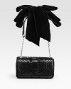 A sleek evening bag that exudes timeless elegance, crafted from rich python and haircalf with a lush velvet bow at the shoulder.Shoulder strap, 10½ drop Magnetic snap flap closure One inside open pocket Faille lining 8W X 4½H X 2D Made in Italy