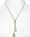 A delicate gold necklace with Lariat knot and double man-made pearl pendant. Designed by Majorica.