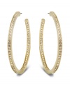 Star-studded style. This elegant pair of gold tone hoop earrings sparkles in clear Swarovski crystal pavé, reflecting the light beautifully and adding a touch of sophistication to any outfit. Approximate diameter: 1-7/8 inches.