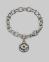 Bold, textured links of sterling silver hold a protective evil eye charm, radiantly created of white, blue and black sapphires with a touch of 18k gold. Sapphires Sterling silver and 18k yellow gold Bracelet length, about 7½ Charm diameter, about ¾ Heart-shaped lobster clasp Made in USA