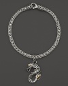 18K yellow gold accents this hand-crafted sterling silver dragon charm bracelet from John Hardy's Naga collection.