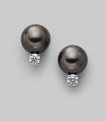 From the South Sea Collection. Classic black cultured pearl studs with sparkling diamond accents, set in 18k gold. 8mm black round cultured pearls Quality: A+ Diamonds, 0.20 tcw 18k white gold Post back Imported