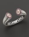 Pavé pink tourmalines surround shimmering, faceted rose quartz on this intricately detailed sterling cuff.