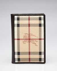 A signature print lends well-traveled flair to this Burberry passport case, which opens to credit card pockets.