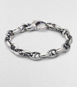 Bold oval links of polished sterling silver have not-so-sinister curved spikes in their centers.Sterling silver Length, about 8½ Lobster clasp Imported