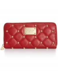 Before your breeze off to Bali, get exquisitely organized with this luxe lovely from MICHAEL Michael Kors. Posh quilted leather is dressed in golden studs and signature detailing, while the pocket-lined interior stows your stash in style.