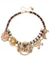 A crowning achievement. This frontal necklace from Betsey Johnson is crafted from gold-tone mixed metal and purple grosgrain ribbon, which provides the foundation for whimsical charms adorned with glass crystal accents. Approximate length: 15 inches + 3-inch extender. Approximate drop: 1-3/4 inches.