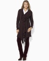 A cozy long cardigan is made ultra-feminine with ruffled trim at the placket and hemline, creating a chic layering essential.