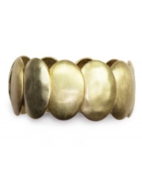 Arm yourself with this bold beauty from Jones New York.  The flat oval disks are crafted from gold tone mixed metal. Stretches to fit wrist. Approximate diameter: 2-3/4 inches.