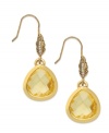 Light as a feather. These teardrop earrings from Juicy Couture float with a feather accent embellished with clear glass accents, sitting atop a faceted amber-hued glass teardrop. Crafted in 14k gold-plated mixed metal. Approximate drop: 1-1/4 inches.