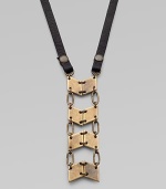 A stunning pendant formed of linked antiqued brass panels boldly suspends from a strap of Italian leather.BrassLeatherLength, about 27½Lobster claspMade in USA