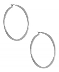 A classic hoop silhouette will never let you down. Nine West's sleek earrings finish off your everyday look. Finished with a click closure. Crafted from imitation rhodium tone mixed metal. Approximate diameter: 2 inches.