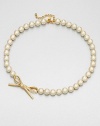 From the Skinny Mini Collection. A classic strand of lustrous faux pearls, sweetly accented with a sparkly bow.Faux pearlsRhinestonesGoldtoneLength, about 18Lobster claspImported