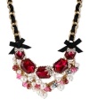 Betsey Johnson's darling frontal necklace showcases a gold tone chain intertwined with black grosgrain ribbon, black grosgrain ribbon bows, fuchsia-colored crystal with glass pearl bows, glass pearls, crystal fireballs, pink faceted beads, pink-colored crystals and gold tone bubble hearts. Crafted in antiqued gold tone mixed metal. Approximate length: 16 inches + 3-inch extender. Approximate drop: 2-1/4 inches.