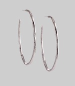 Delicate yet dramatic hoops of hammered sterling silver. Sterling silver Diameter, about 1¾ Post back Imported