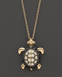 Black and white diamonds set in a 14K. yellow gold turtle pendant.