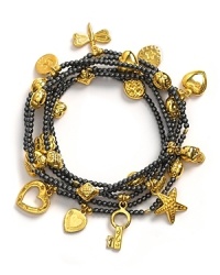 Good Charma gunmetal beaded bracelet set with gold mini charms. A set of six gunmetal and gold stretchy beaded bracelets with charms. Charms include tassel, dragonfly, wish bone, heart and key.