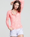 An ornate burnout design makes a subtle statement on this Free People henley top.