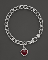 A faceted red corundum heart charm decorates a classic bracelet from Judith Ripka.